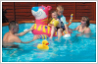 Add duck to photograph of family in swimming pool.