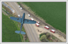 This is a photo manipulation example in which a plane model has been added to an aerial view of the ground below as one sees it while flying overhead in an aircraft.