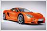 Photo editing example: Photo of Ascari race car (originally orange paint work) edited to change colour to pink and golden-brown options 
