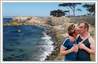 This is a photo editing sample of a gay couple taken out of a crowded London Gay Pride event photograph, and set against a beautiful nature scenery by the sea.