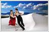 Background has been replaced in ice skating photo. Skating couple has been moved to a white sand dune picture.