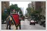 Photo manipulation example of changing the background of a picture. The image of a woman on an elephant has been placed on a crowded New York street.