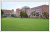 Photo editing used to add All India Institute of Medical Sciences (AIIMS) logo to Institute's lawns as grass sculpture. Building and surrounding landscape enhanced.