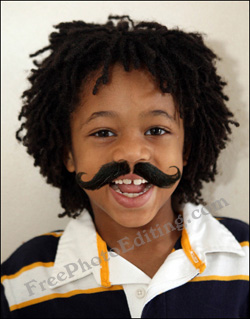 Moustache added to little boy's face with the help of photo editing.