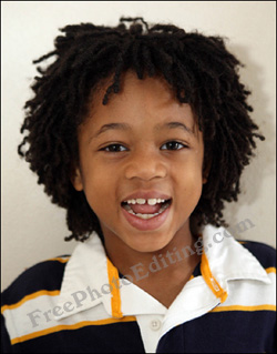 Photo of a cheerful 8-year-old boy dressed in yellow and white t-shirt