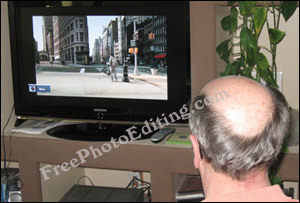 Balding man watching TV
