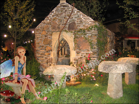 This is a photo editing example in which the image of a fairy has been added to another photo with a cottage and a garden outside. 