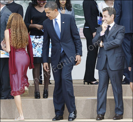 The woman seen in this photo needs to be removed and replaced with a dog. The edited photo can be seen below. Obama and Sarkozy are staring at the woman's ass unashamedly.