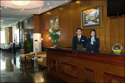 Photo manipulation services required: The receptionist seen in this hotel lobby photo wants a Hollywod celebrity to be placed in the photo.