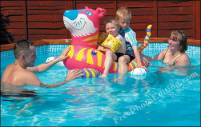 A family enjoying themselves in the swimming pool