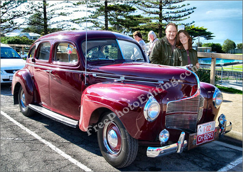 This is a photo editing example of 'merge photos' or 'change background'. In this image you see a couple merged into the photograph of a classic Dodge.