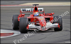 Red race car on race track, taking a curve