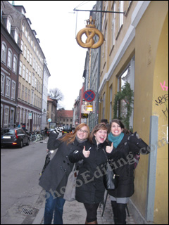 Three excited young girls, dressed for the winters, in a street in Copenhagen