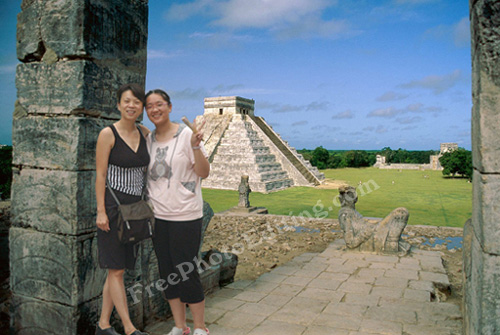 This is a photo editing example. The girls seen have been plucked out of a street photo and planted in this Chichen Itza picture.