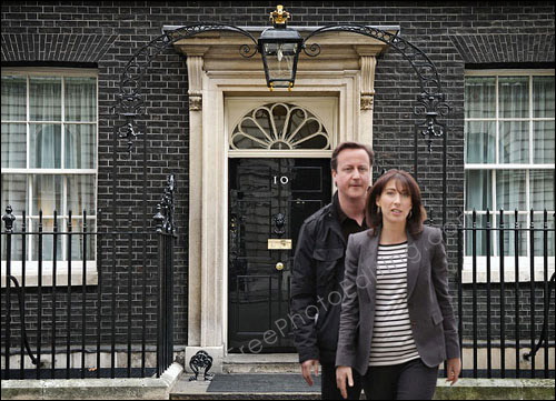 This is a photo editing example (of background change) in which (now) U.K. prime minister David Cameron and his wife Samantha have been taken out of a Milton Keynes Academy photo (taken 27th March 2010) and placed in front of 10, Downing Street.
