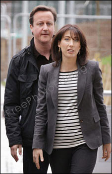 Photo editing required: David & Samantha Cameron to be placed at the 10, Downing Street front door. (This is a March 27, 2010 photo of UK's conservative party leader David Cameron and his wife Samantha arriving at the Milton Keynes Academy on March 27, 2010 in Milton Keynes, England, to address local supporters ahead of his race for prime-ministership.)