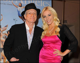 Photo retouching job: The images of Hugh Kefner and Crystal Harris need to be extracted from this photo and placed in a 'Hollywood sign' picture. This is to mark Hugh Kefner's engagement and acknowledge his generous support towarsd saving the Hollywood sign. The edited photo can be seen below.