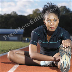 Athlete on race track in sports stadium