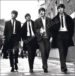 Before photo editing: This is a black and white poster of The Beatles. It shows the group, as young men, walking on a London street, in their trademark swagger. The background needs to be changed in this photo to a park view in autumn.