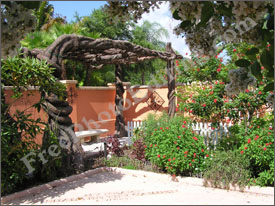 This is an outdoor shot in which there are colourful flowers and an elaborate natural tree sculpture. The group in photo on left needs to be moved into this picture.