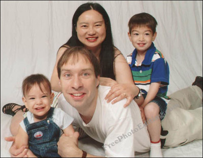 Family photo of four -- two small children and their young parents.