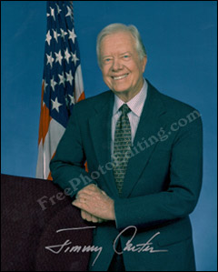 Former U.S. president, Jimmy Carter, standing beside the U.S. flag