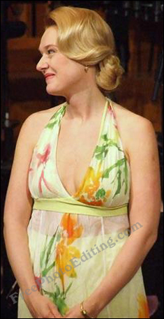 Woman wearing lovely lemon coloured sleeveless dress in floral print.