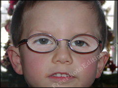 Eyeglass glare in little boy's spectacles fixed with photo editing