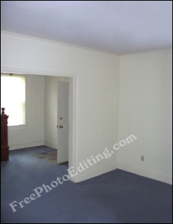 This photograph has been edited to remove a monstrous ceiling fan and repair stained and torn carpetting below fan.