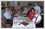 Photo editing to fix underexposed photograph. Far end of photo is dark and subjects can hardly be seen. Exposure correction or exposure compensation carried out on photograph taken inside a restaurant.