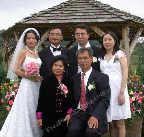 Edited wedding photograph in which the short bridegroom now looks taller than the bride.