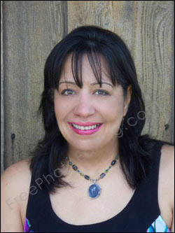 This is a photo editing example in which a middle-aged woman has been made to look younger. Blemishes on the face have been touched up; under-eye bags have been retouched; extra fat on the face has been removed. Original unedited photo can be seen on left.