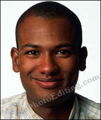 Passport size photo of young African-American man. Face is partially illuminated due to uneven lighting.