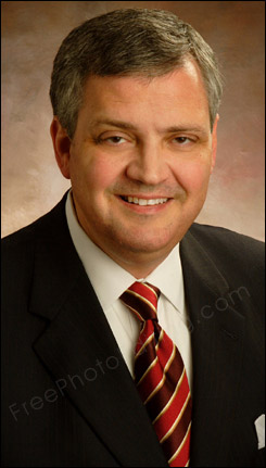 This photo needs retouching to open the the man's half-closed eyes. Retouched photo can be seen on right.