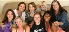 Group photo of young women seated on couch. Woman in black t-shirt is plain looking.
