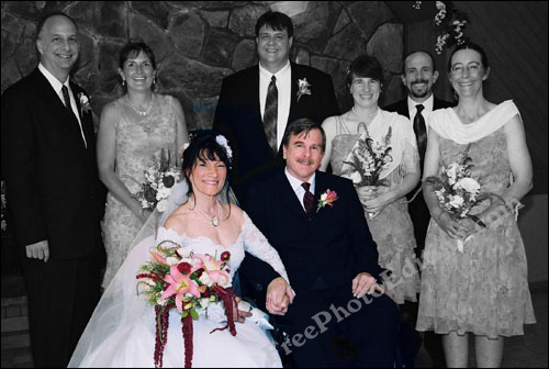 Wedding photograph in which the bride and bridegroom are in colour, and the rest of the group is in black and white (or grayscale). This special effect has been created using photo editing.