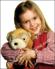 Little girl in red checks cuddling her teddy bear