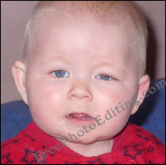 Adorable baby with one eye partially closed / suddenly squinching