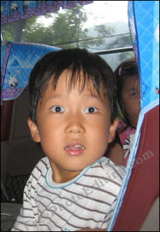 Squint in the boy's right eye has been corrected using photo editing.